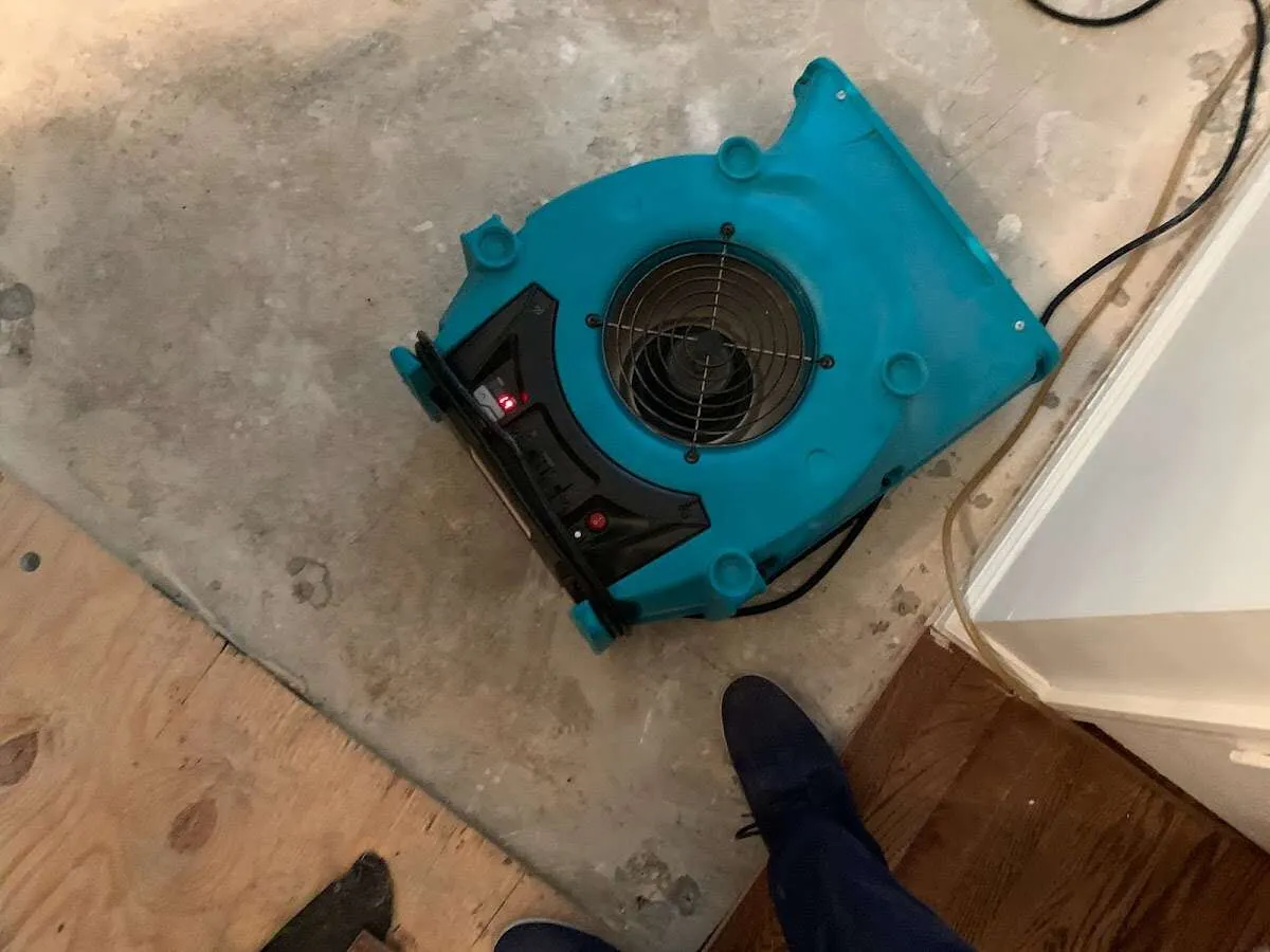 Air mover drying subfloor during Leak Detection & Repair in King City